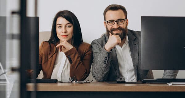 two-business-partners-working-together-office