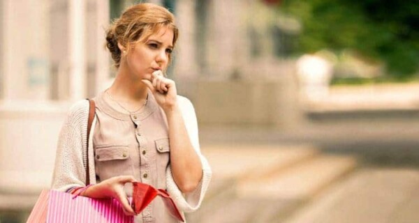 woman thinking with purse
