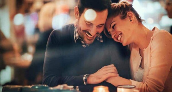 man and woman laughing in hotel