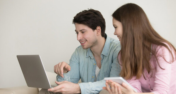 young-man-woman-using-laptop